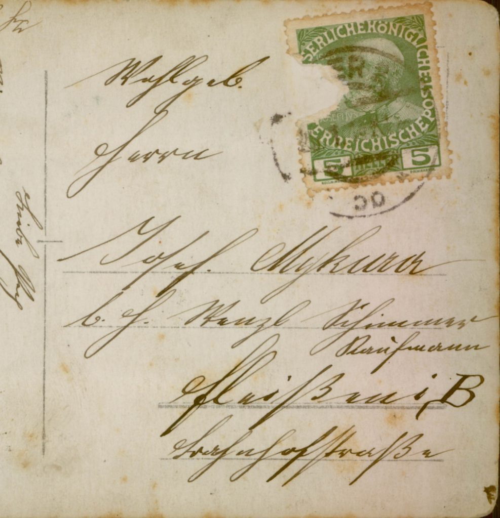 Post card with torn green stamp